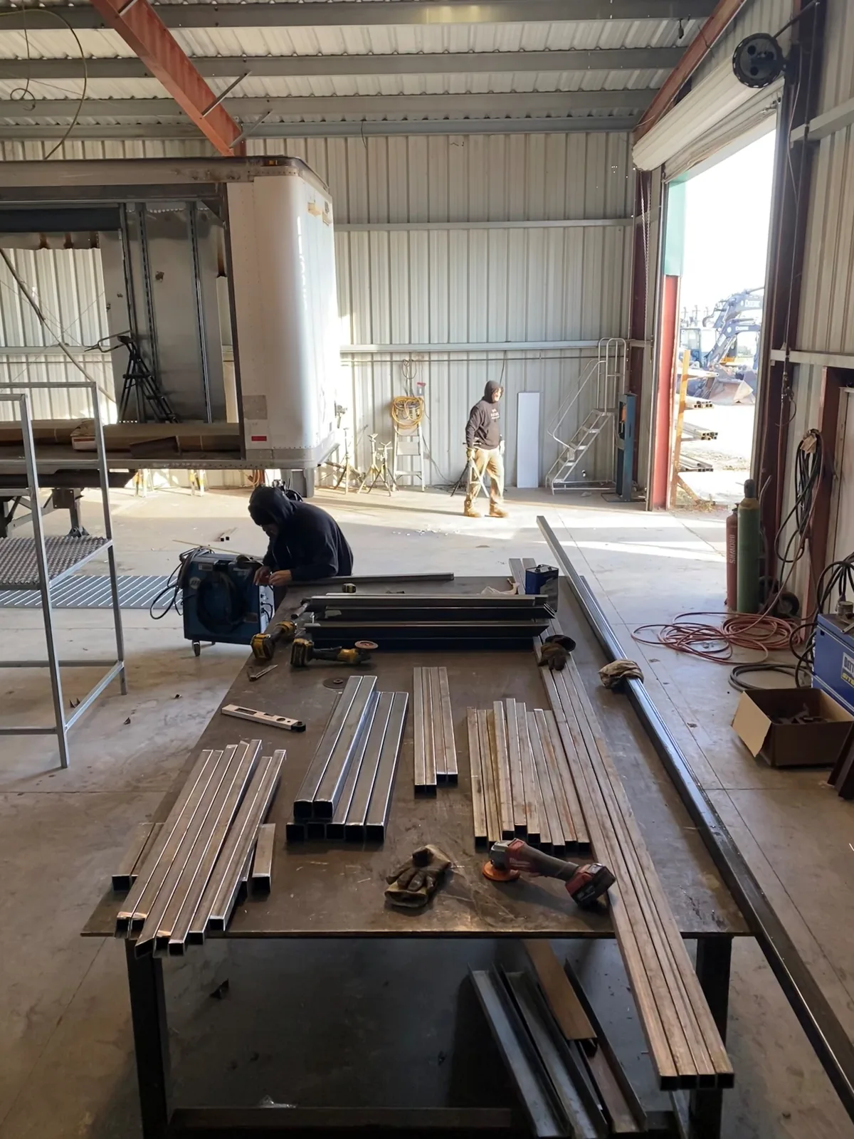 Fabrication team preparing floor and structural materials